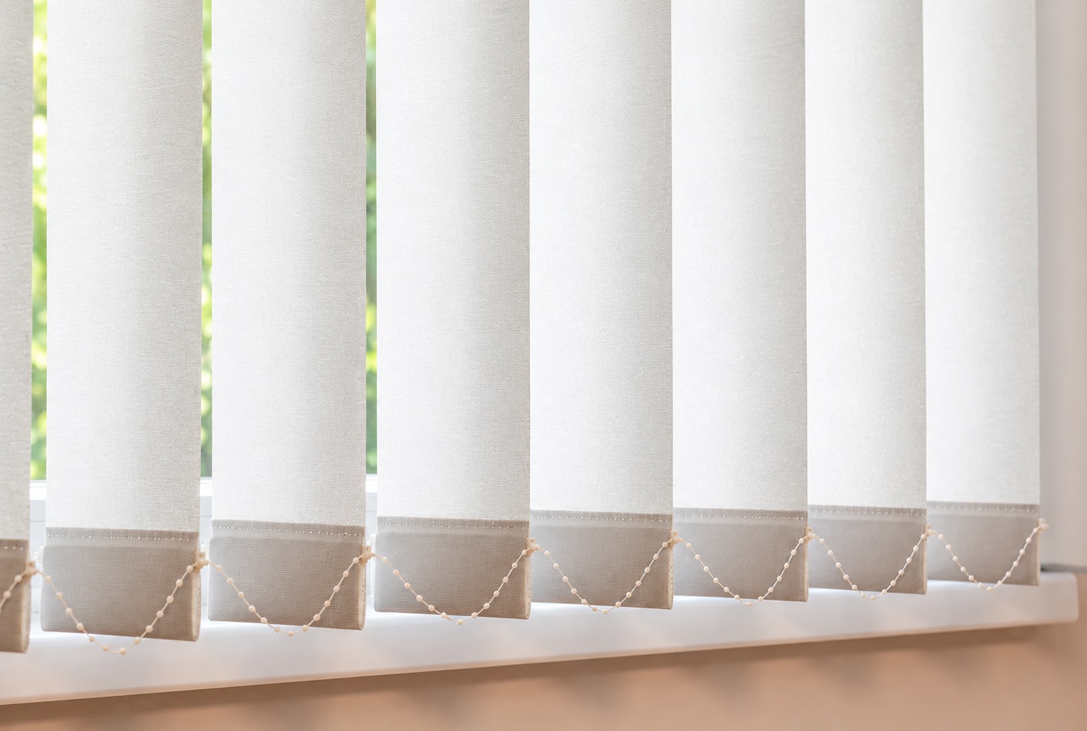 Vertical blinds providing wide coverage for sliding glass panels